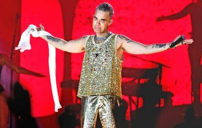 Robbie Williams recalls soiling himself on stage with Take That - www.nme.com - Britain - Denmark - city Amsterdam