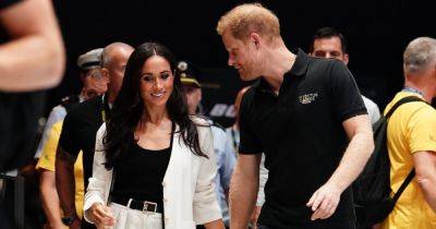 Prince Harry & Meghan pack on the PDA as she apologises for being late to Invictus - www.ok.co.uk - Australia - Ukraine