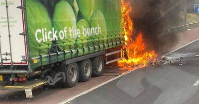 Moment Asda lorry goes up in flames on M60 as drivers trapped in traffic chaos - www.manchestereveningnews.co.uk - Manchester
