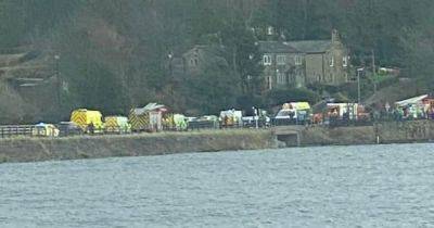 Emergency services swarm road after woman, 70, on mobility scooter falls into lake - www.manchestereveningnews.co.uk - Manchester