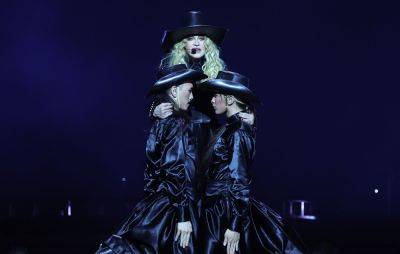 Watch Madonna’s smooth recovery after falling off a chair during show - www.nme.com - Britain - USA - Seattle