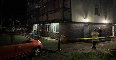 Man dead after 'falling from height' while police execute warrant at apartment block building in Collyhurst - www.manchestereveningnews.co.uk - Manchester
