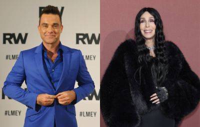 Robbie Williams left “headbutting the wall” after “rude” encounter with Cher - www.nme.com