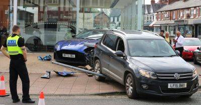 Driver mounts car onto £200,000 Aston Martin outside dealership after 'losing control' - www.manchestereveningnews.co.uk - county Lane