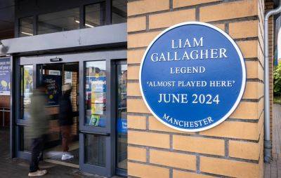 Blue plaque installed at Manchester Lidl to honour Liam Gallagher “almost” playing there - www.nme.com - Britain - Manchester